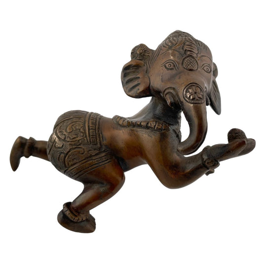 Bronze metal statue of Ganesh, the Hindu elephant-headed god, in a crawling position with decorative details on the body and head.